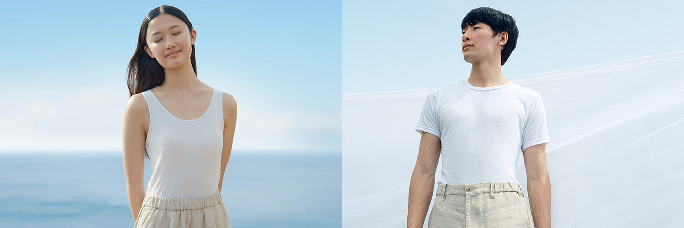 Woman & Man wearing moisture-wicking innerwear against a clear blue sky. 