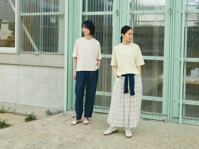 2 women standing out doors in MUJI Apparel