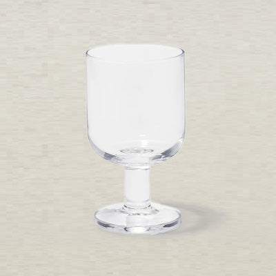 Clear glass goblet on a light gray background