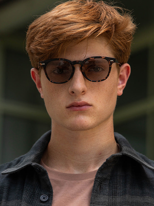 Person wearing sunglasses with a blurred background