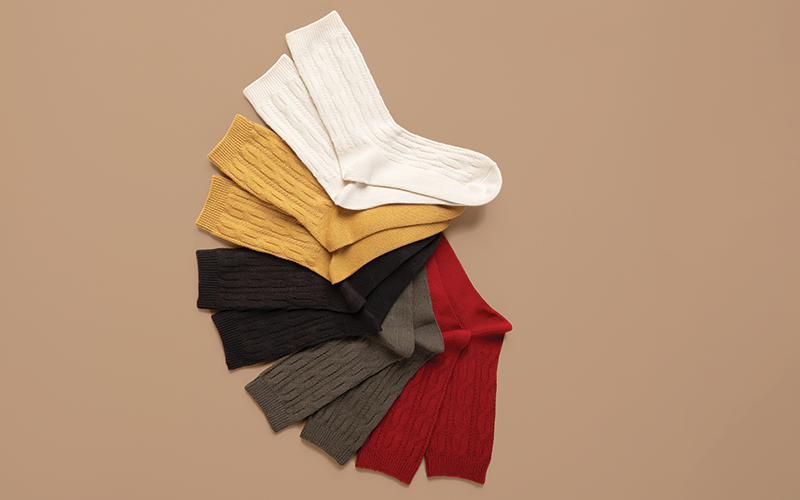 Set of colorful socks arranged on a beige background