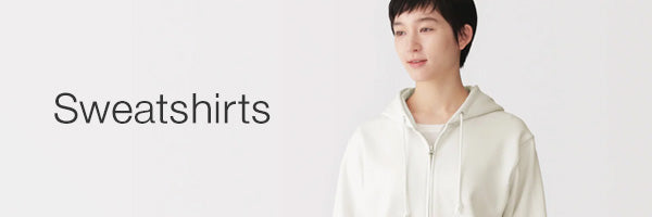 A person wearing a light beige zip-up hoodie stands against a plain white background, with the word 'Sweatshirts' printed on the left side.