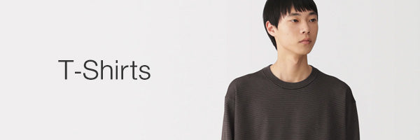 A man wearing a dark charcoal gray crewneck t-shirt, shown from the chest up against a plain white background, with the text 'T-Shirts' printed on the left.