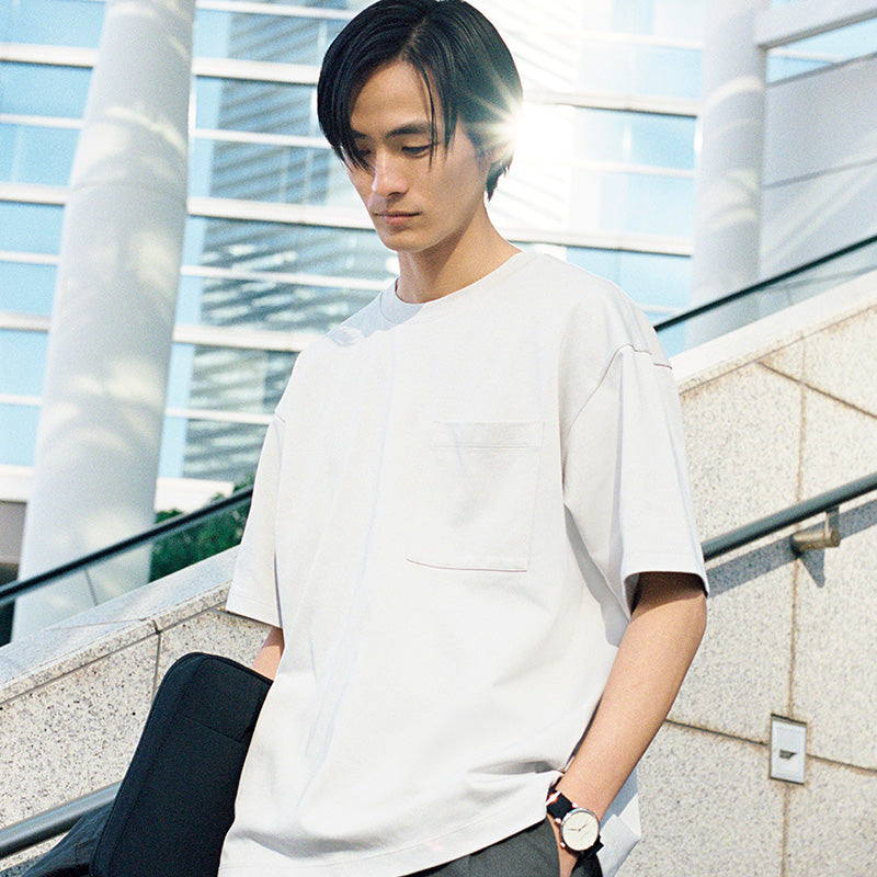 Man in Cool Touch S/S Shirt walking down stairs.