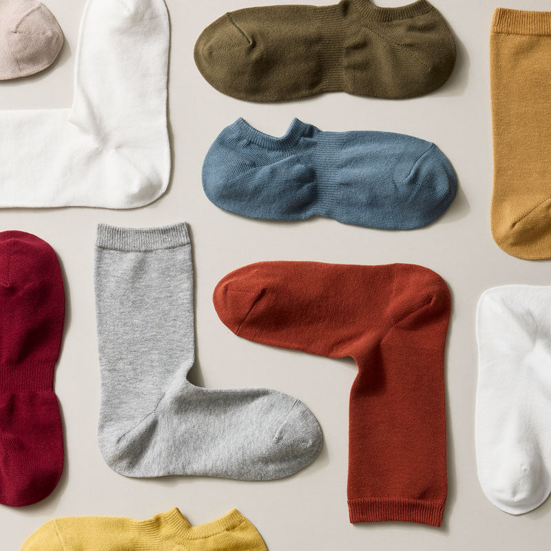 An assortment of knit ankle socks in multiple colors.
